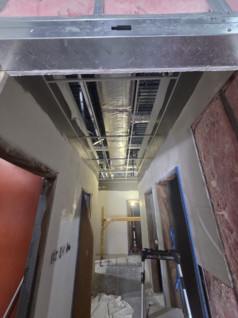 AEPX Construction — active job site, drywall and MEP rough-in